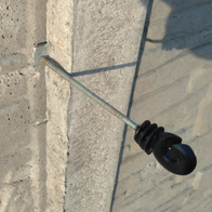 Bracket for non-invasive installation of the insulator on a concrete fence